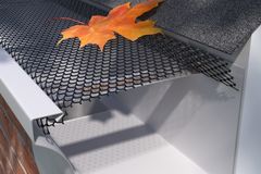 Leaves and debris collected on top of a gutter guard along a roofline