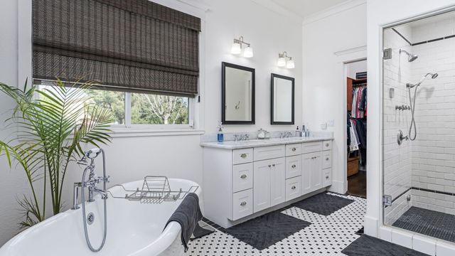 Remodeled bathroom with a freestanding tub, double vanity and glass walk-in shower
