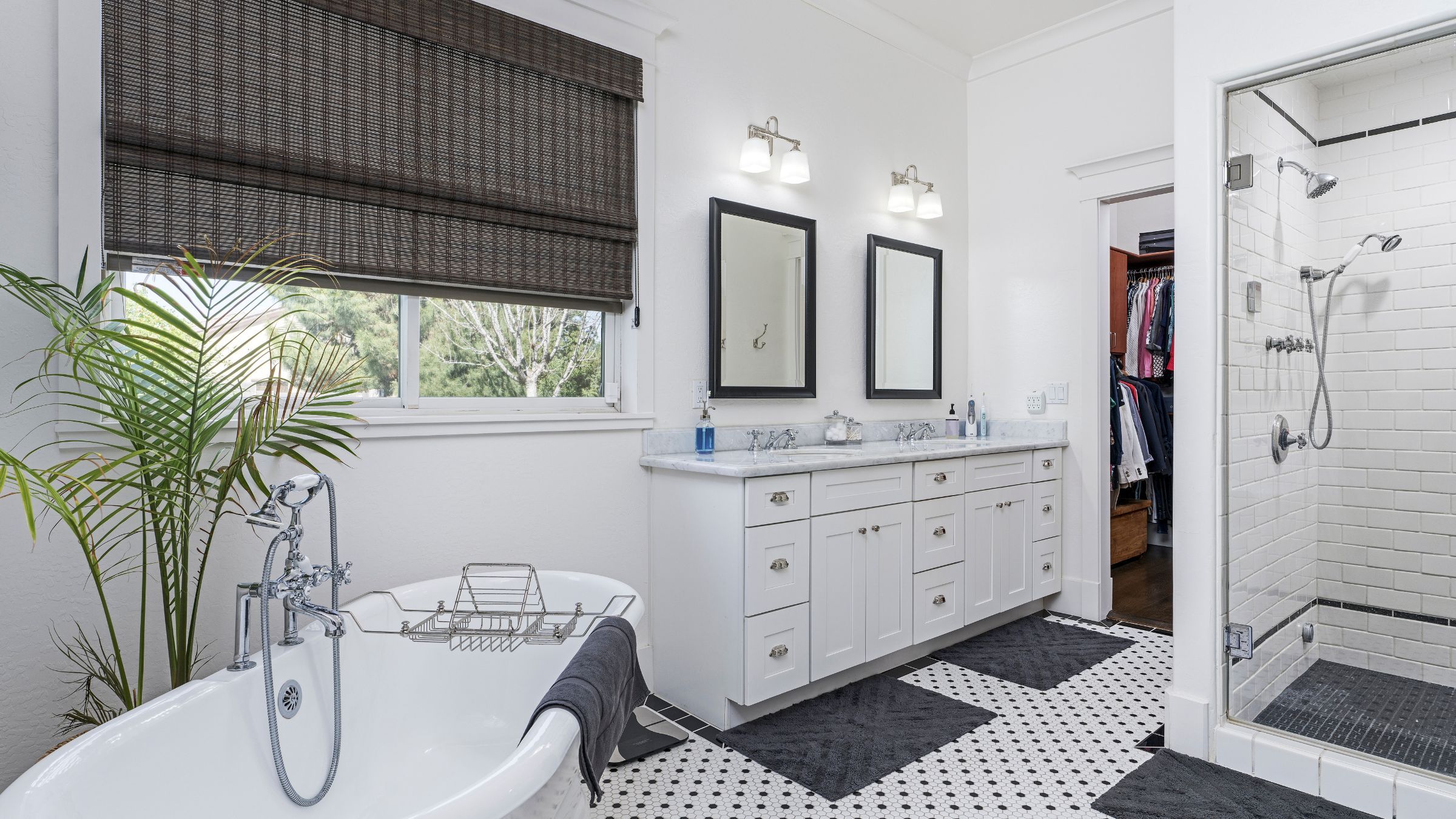 Remodeled bathroom with a freestanding tub, double vanity and glass walk-in shower