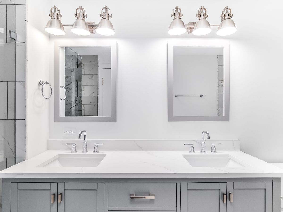 Finished double vanity with quartz top, framed mirrors and vanity lighting