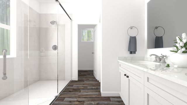 Finished bathroom with a tiled shower, vanity and mirror