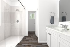 Finished bathroom with a tiled shower, vanity and mirror
