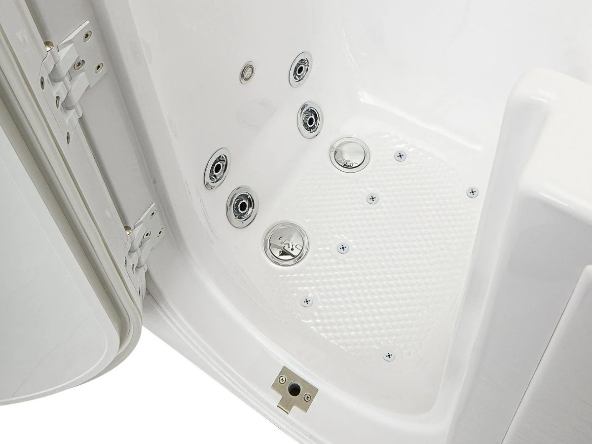 Close-up of a walk-in tub door hinge and gasket beside the textured tub floor
