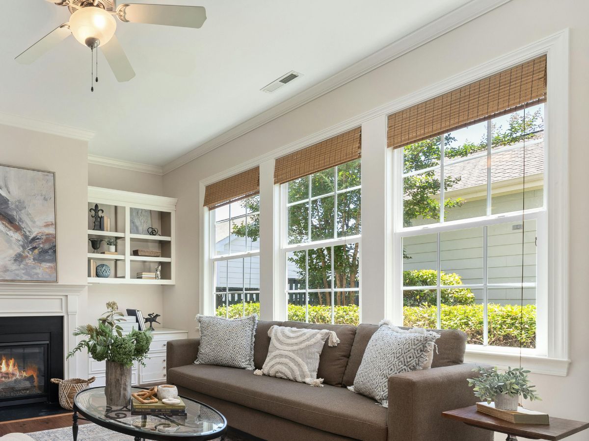 Living room with three new double-hung windows letting in daylight