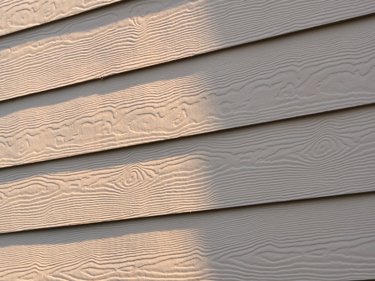 Close-up of fiber cement lap siding showing its woodgrain texture