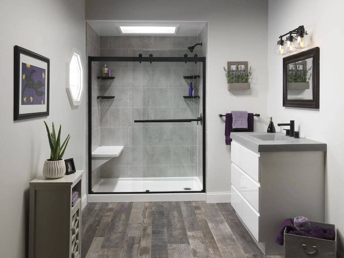 Walk-in shower with a sliding glass door and a low-profile pan