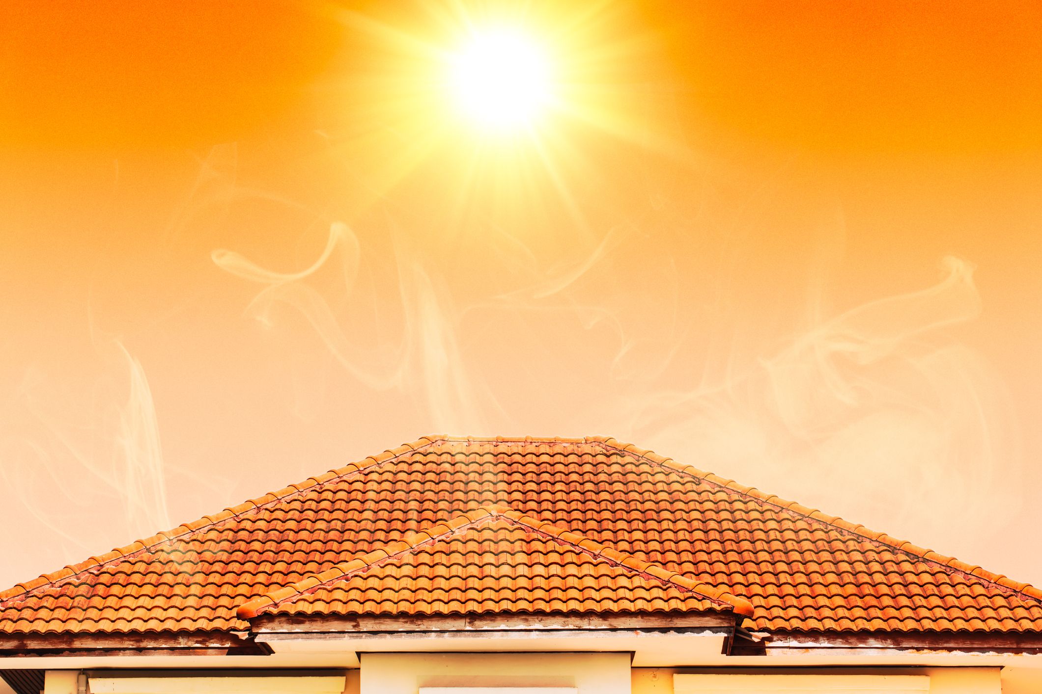 Clay tile roof on a home under bright sun