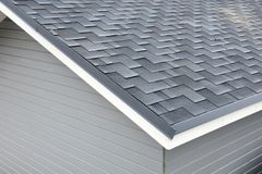 Architectural asphalt shingles showing layered shadow lines on a residential roof