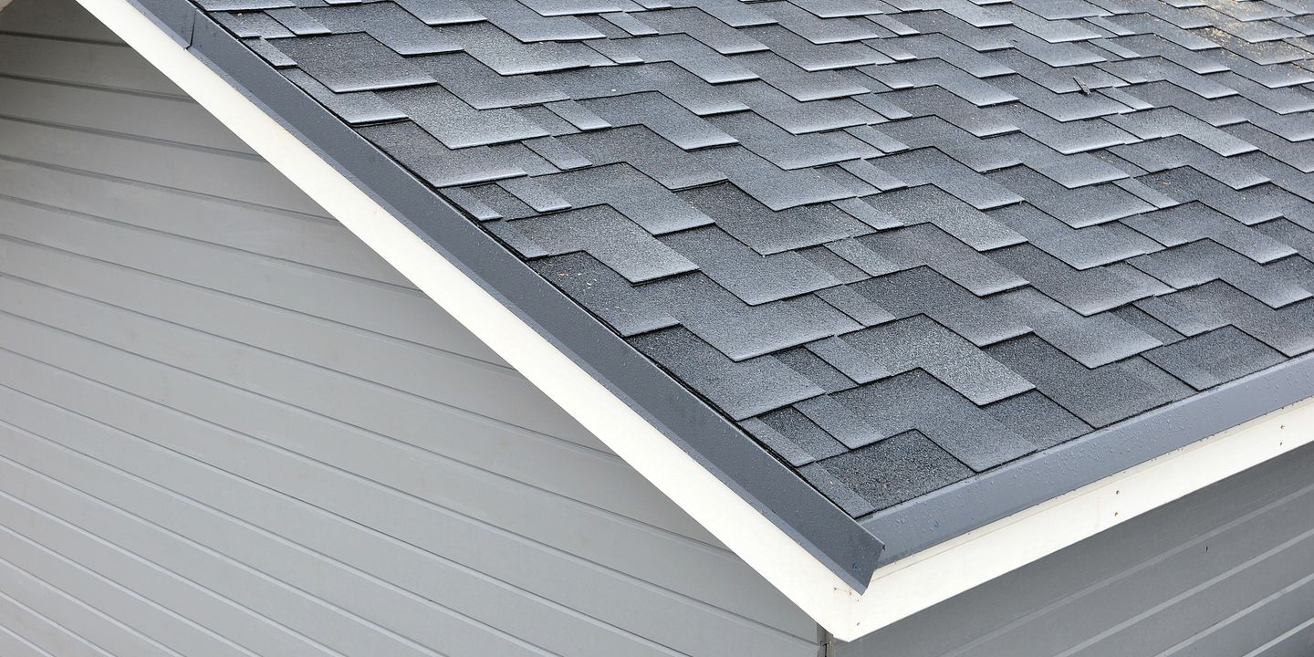 Architectural asphalt shingles showing layered shadow lines on a residential roof