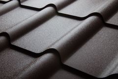 Stone-coated metal shingles laid to resemble traditional shingle courses
