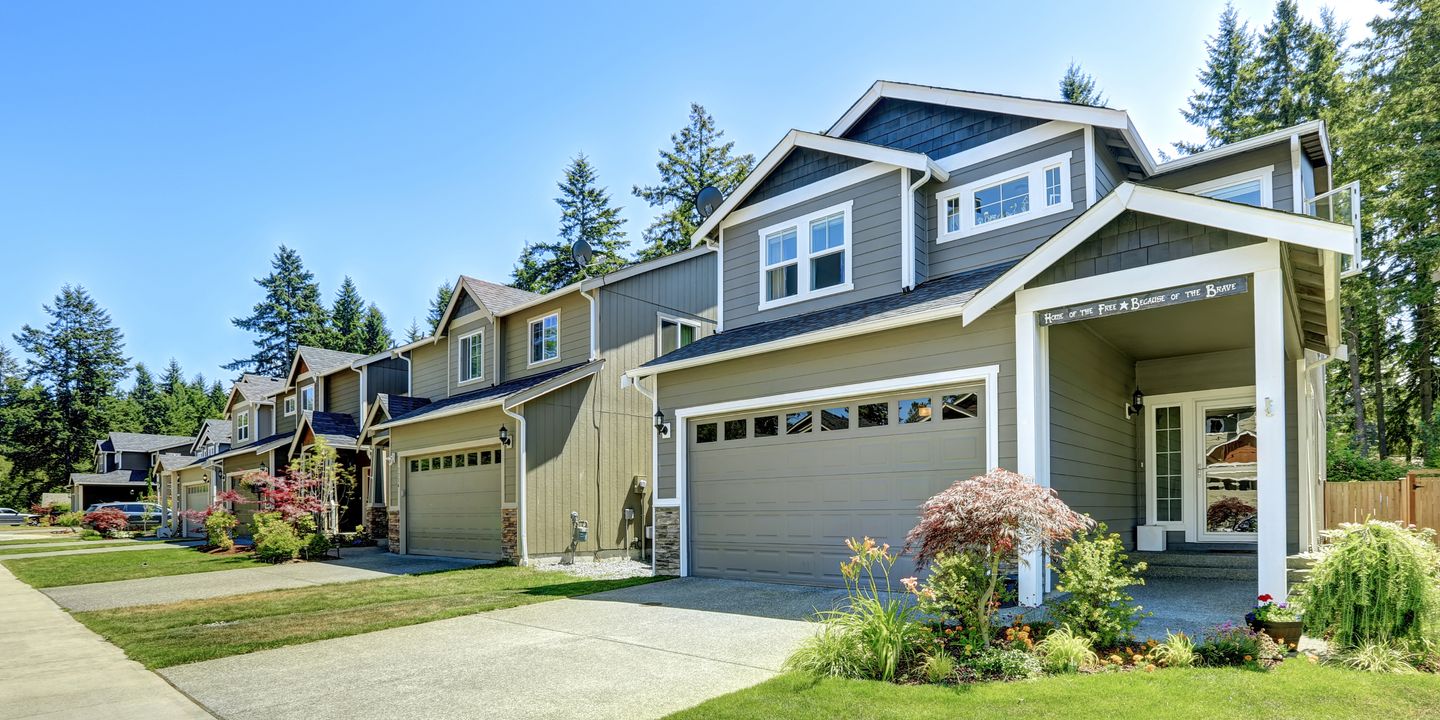 Two-storey homes with lap siding, shingle roofs and new windows on a residential street