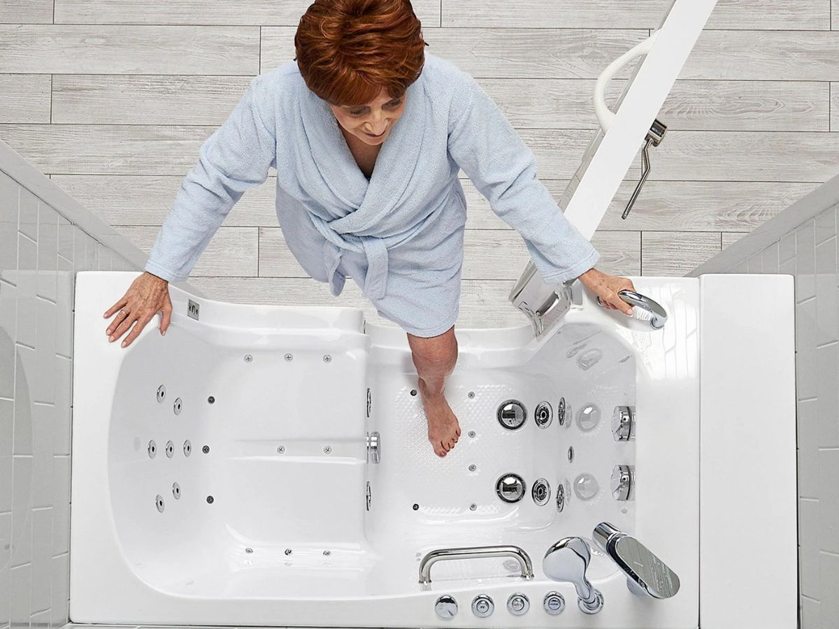 Overhead view of a walk-in tub interior showing the built-in seat, grab bar and jets