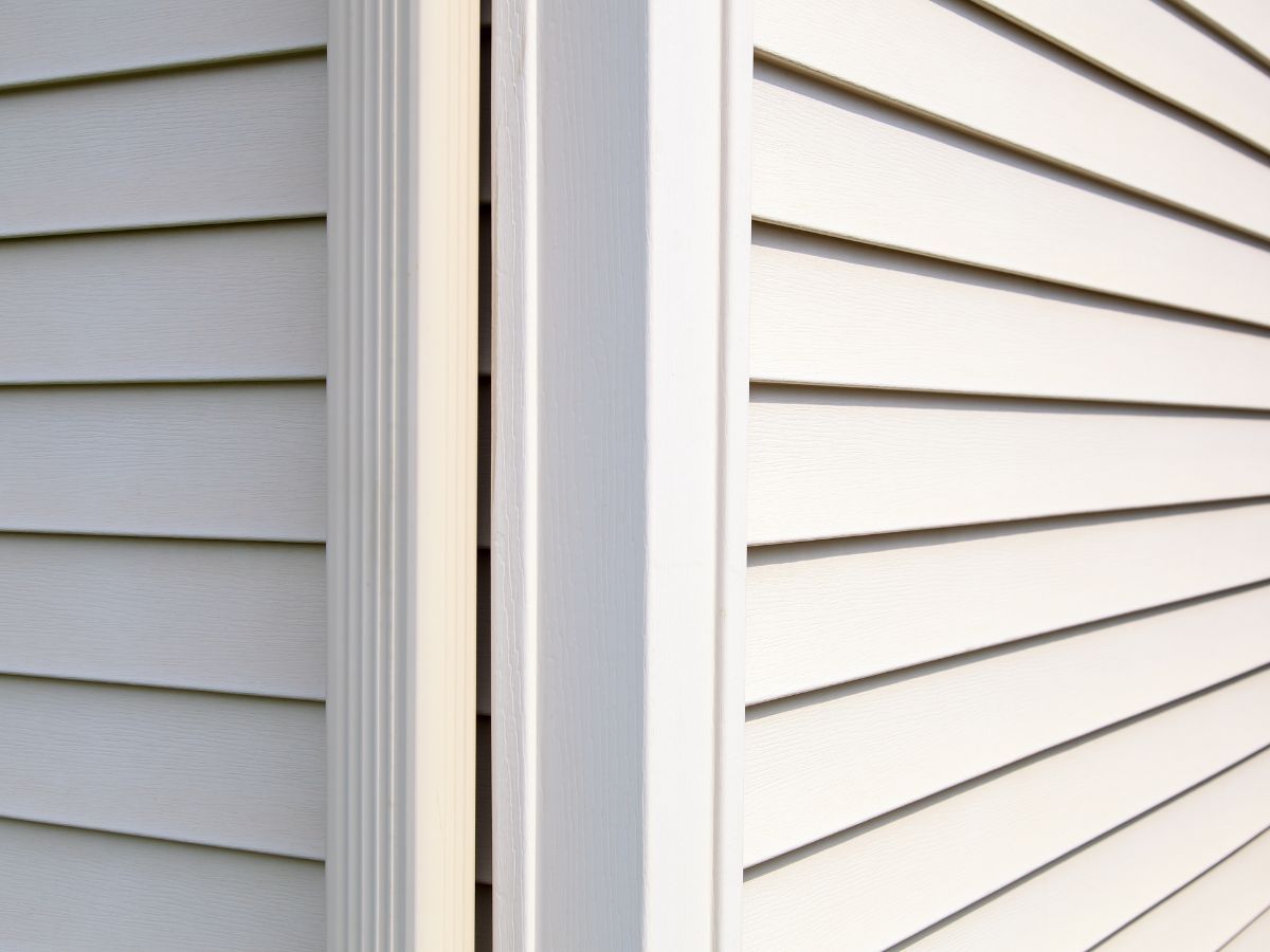 Corner post joining two runs of lap siding at the corner of a house