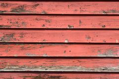 Aged lap siding on a house wall showing chalking and colour fade