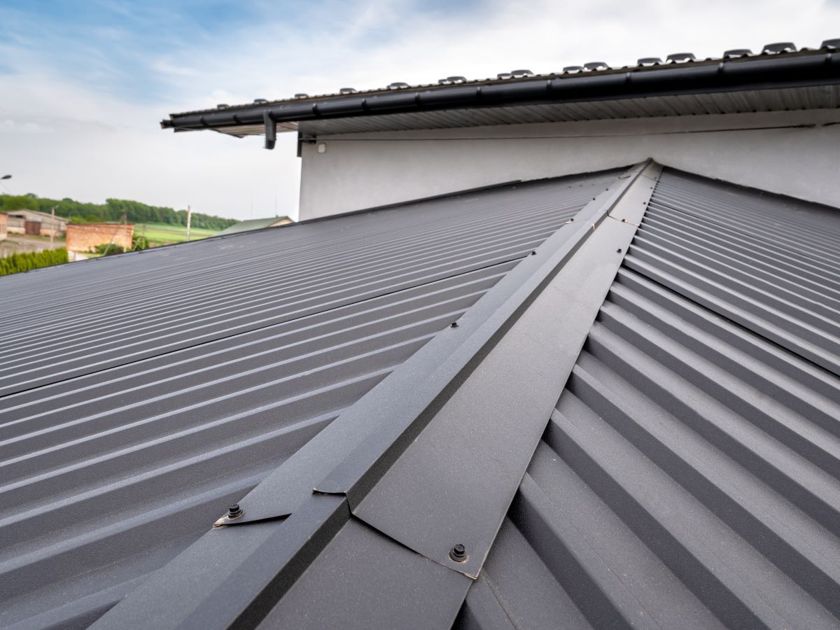 Standing seam metal roof on a house with chimneys, seen from above