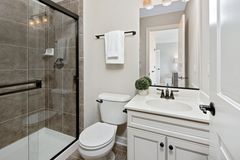 Walk-in shower built into a former bathtub alcove