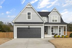 Two-storey home with newly installed lap siding and white trim