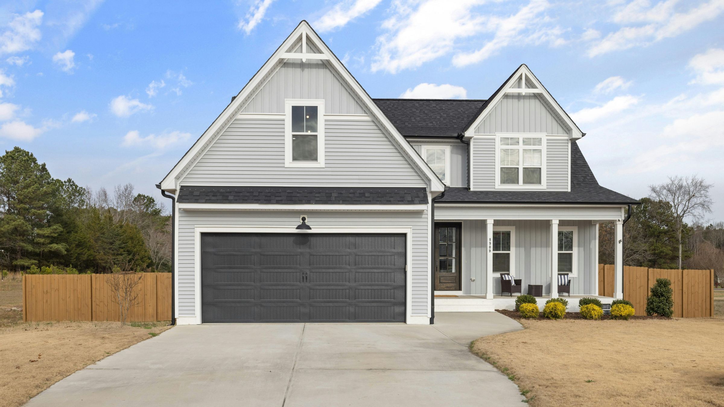 Two-storey home with newly installed lap siding and white trim