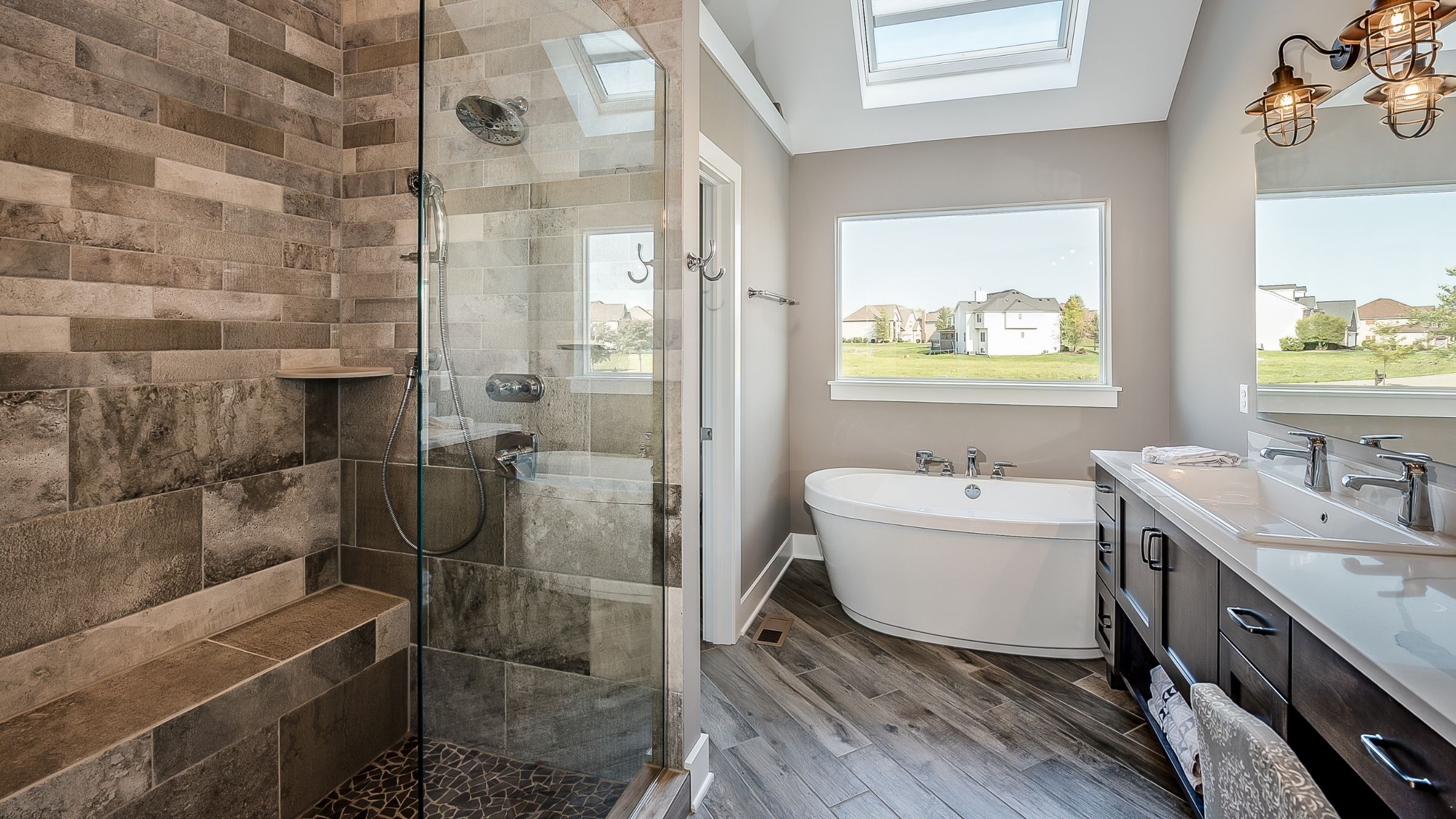 Open doorless walk-in shower in a bright tiled bathroom