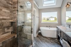 Open doorless walk-in shower in a bright tiled bathroom