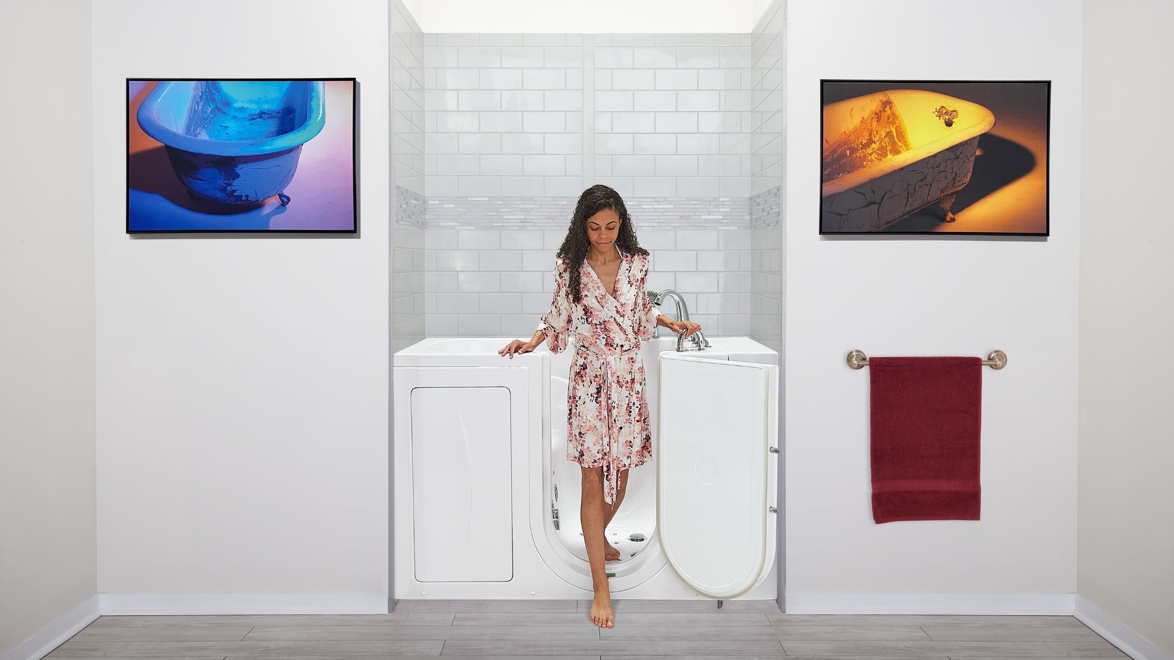 Walk-in tub with its door open beside a tiled bathroom wall