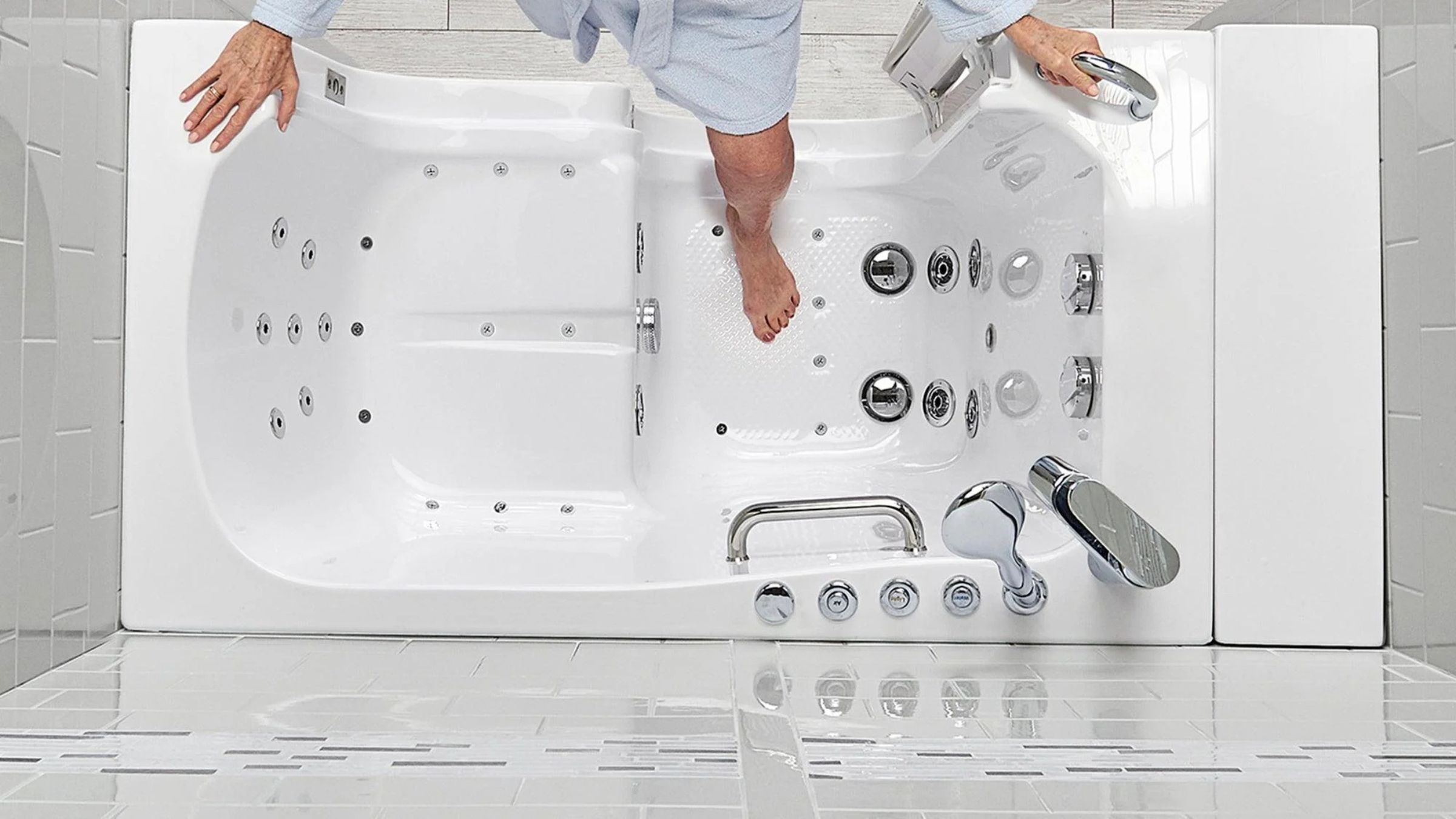 Walk-in tub with an integrated grab bar and handheld shower attachment